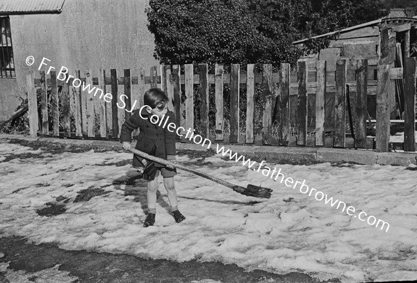 CHILD PLAYING WITH SHOVEL